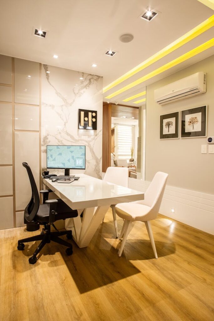 pexels-photo-3316924 Elegant modern office interior featuring a sleek desk, chairs, and ambient lighting for a sophisticated environment.