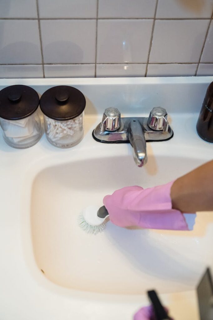 pexels-photo-9462644 A Person Cleaning a Sink